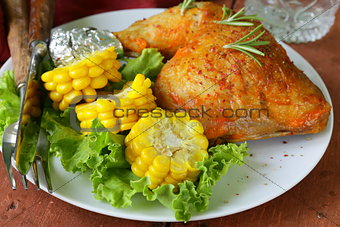 baked chicken leg with corn for garnish