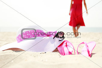 girl with flip-flops on the beach