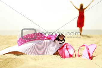 girl with flip-flops on the beach 