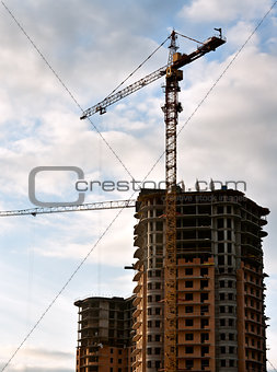 Stand, house, construction crane in the sky with clouds