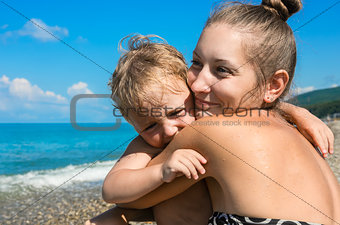 mum with small son on beach