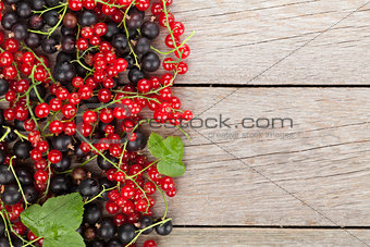 Fresh ripe currant berries on wooden table