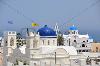 white greek church with blue roof on santorini island