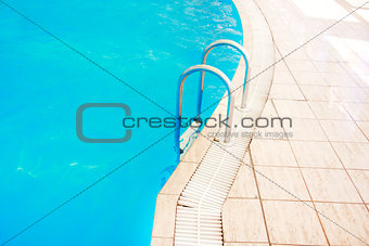 steps in a blue water pool