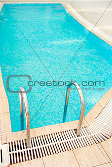 steps in a blue water pool 