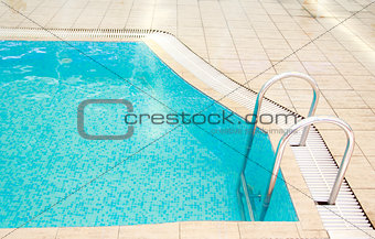 steps in a blue water pool 