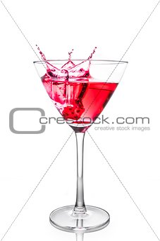 red dice falling in the red cocktail glass with splashes