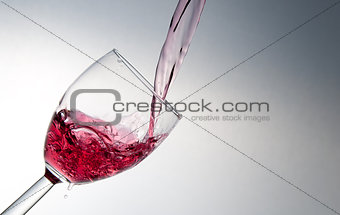 Wine being poured into a glass.
