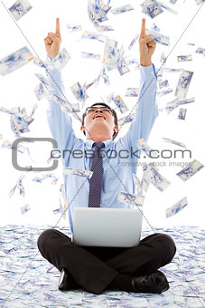 excited business man raise hands with money rain background