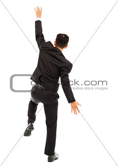 young business man climbing a wall with white background
