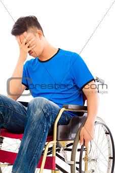 depressed and handicapped man sitting on a wheelchair