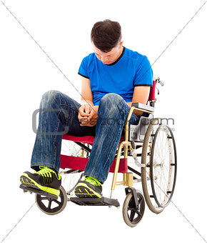 frustrated handicapped man sitting on a wheelchair 