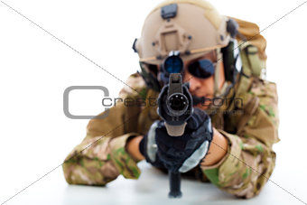 Soldier with rifle against and lying on floor.isolated on white 