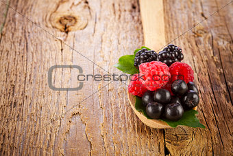 Fresh berries in wooden spoon