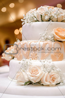 Beautiful wedding cake decorated with orange roses