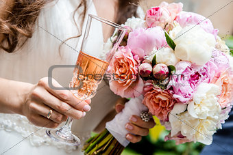 Beautiful bridal bouquet  and glass of champagne close-up