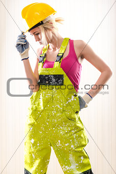 Female construction worker posing indoors