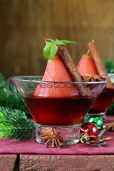 pears cooked in wine with spices (cinnamon and anise) Christmas table setting