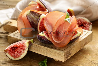 ripe purple figs with smoked ham - a traditional antipasti appetizer
