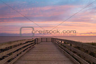 Boardwalk on beach at dawn