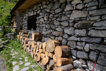 Side of old cottage with wood pile