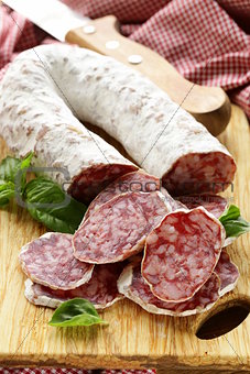 delicacy smoked sausage (salami) on a wooden board