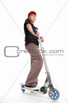 Boy standing on a scooter