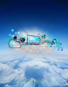 Composite image of laptop on floating cloud with apps