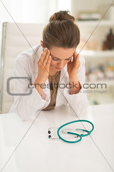 Portrait of stressed doctor woman in office