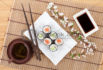 Sushi maki set with salmon and cucumber and green tea
