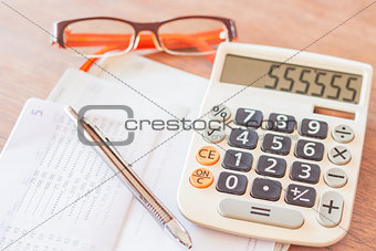 Work station with calculator, pen and eyeglasses