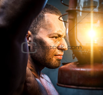 Portrait of young man with oil lamp
