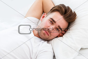 Young man in the bed