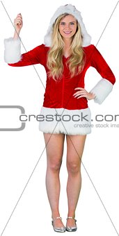 Pretty girl in santa outfit holding hand up