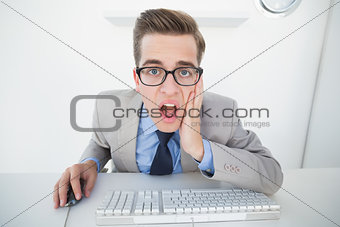Shocked businessman working on computer