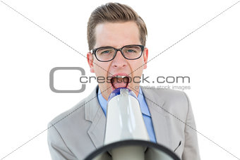 Nerdy businessman shouting through megaphone