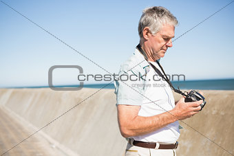 Happy senior man looking at his camera