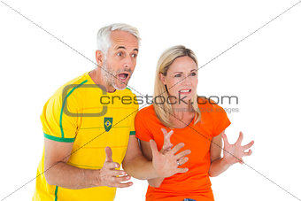 Football fan couple looking nervously ahead