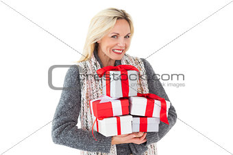 Smiling woman in winter fashion holding presents