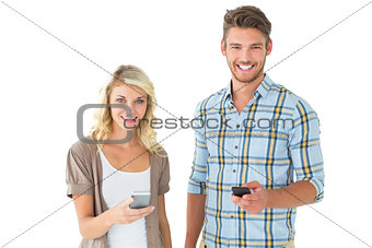 Attractive couple using their smartphones