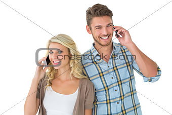 Attractive couple talking on their smartphones