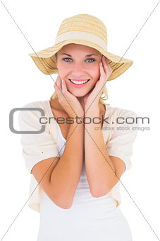 Attractive young blonde smiling at camera in sunhat