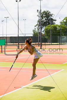 Pretty tennis player serving the ball