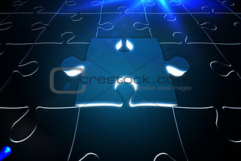 Blue glowing jigsaw piece on puzzle