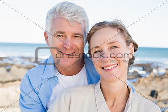 Happy casual couple by the coast
