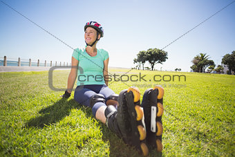 Fit mature woman in roller blades on the grass