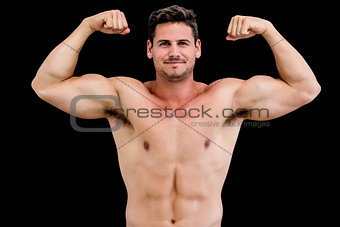 Portrait of shirtless muscular man flexing muscles