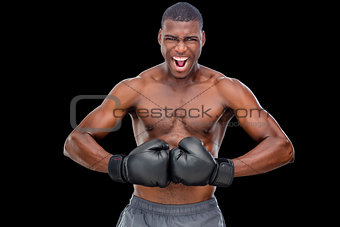 Portrait of shirtless muscular boxer flexing muscles