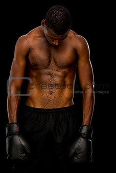 Shirtless boxer over black background