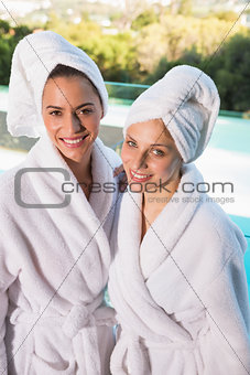 Smiling young women in bathrobes
